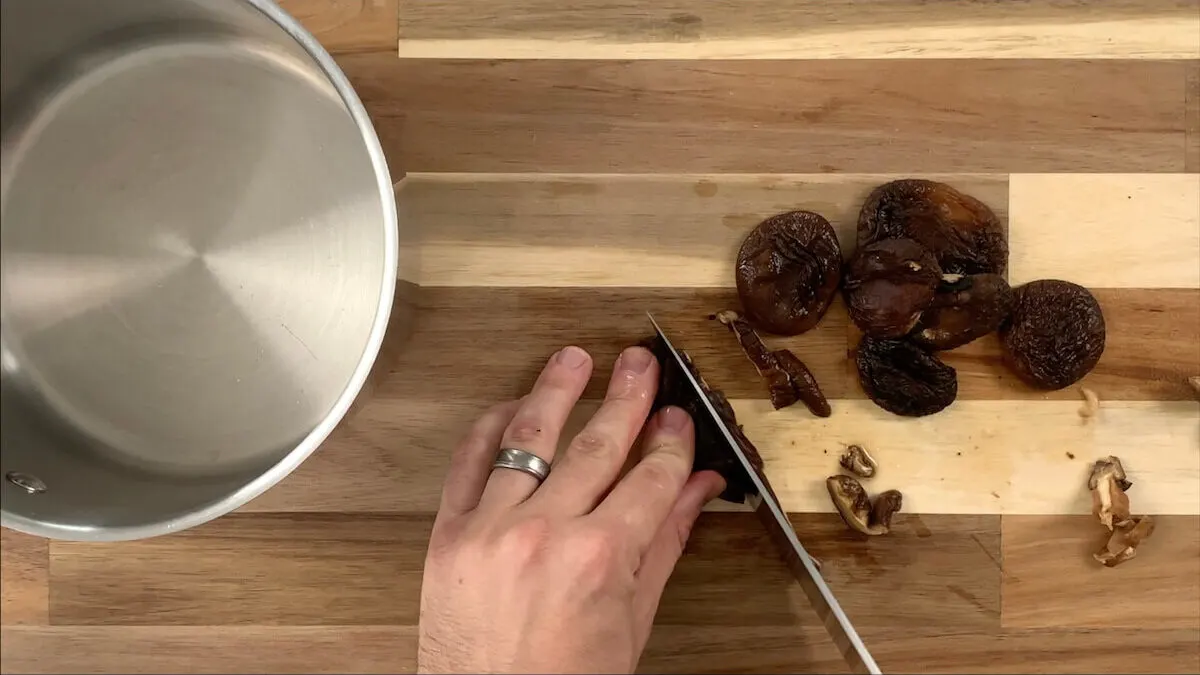 Cut stems off of shiitake mushrooms and slice into thin slices.