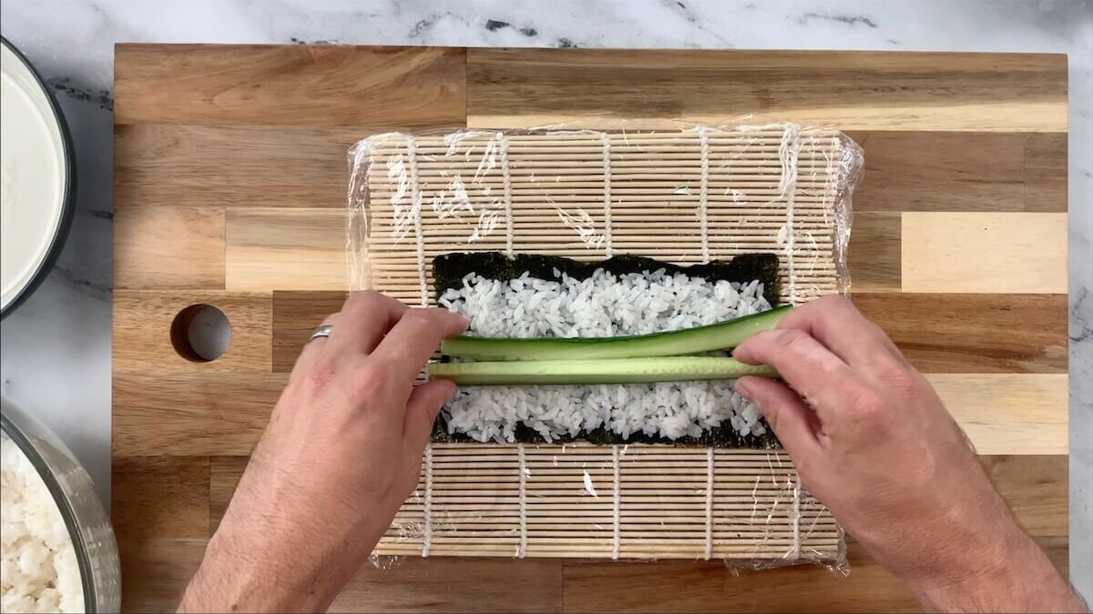 Add two slices of cucumber to the cucumber roll. 