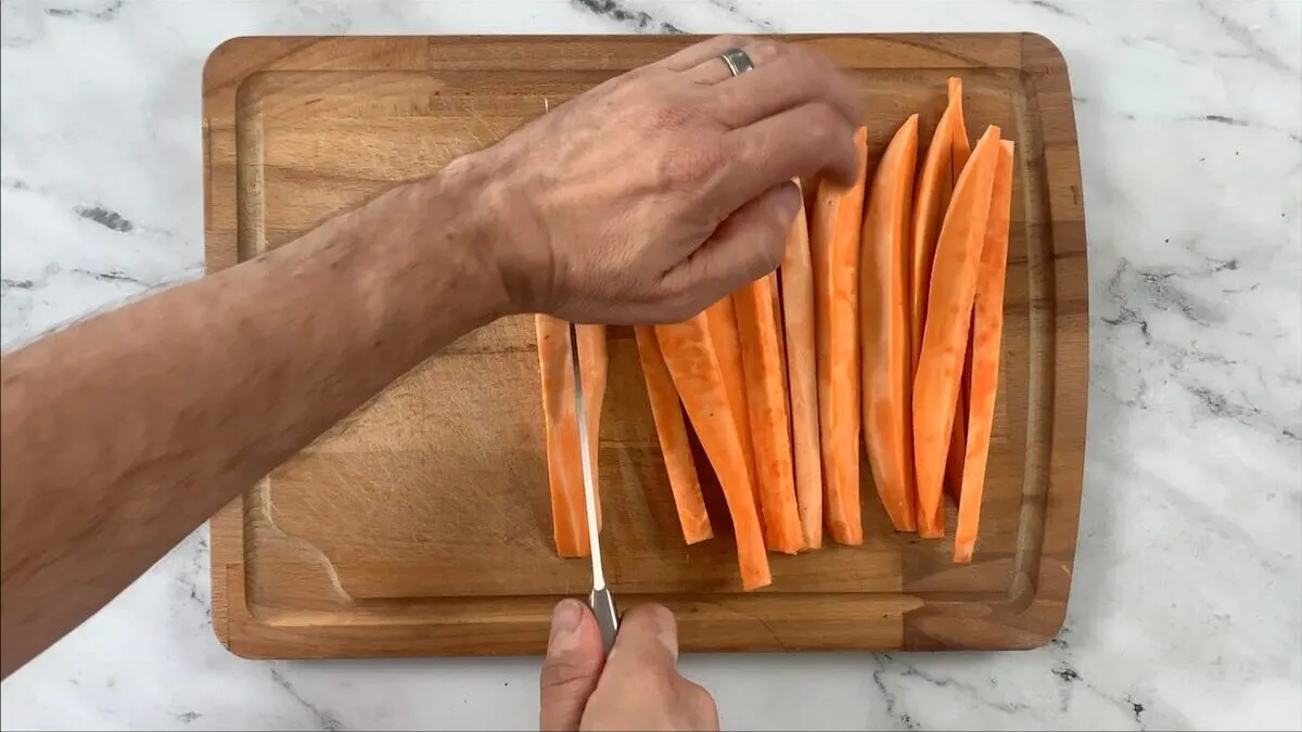 Cut sweet potatoes into strips that are the same length as the nori sheet is wide.