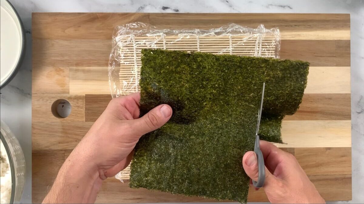 Cut the top 1/4 from the nori sheet.  This helps to make the salmon skin roll bite sized.