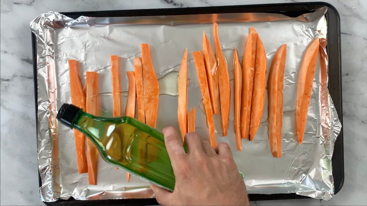 Drizzle the sweet potatoes with avocado oil.