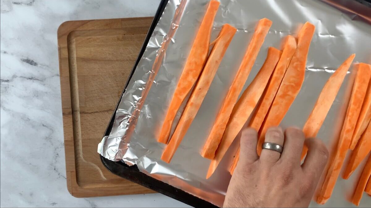 Add the sweet potato strips to the baking sheet.