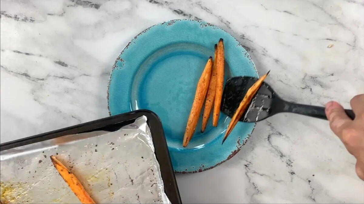 After the sweet potatoes are done cooking, remove from the baking sheet and place on a plate until they are ready to be used in the sweet potato roll.