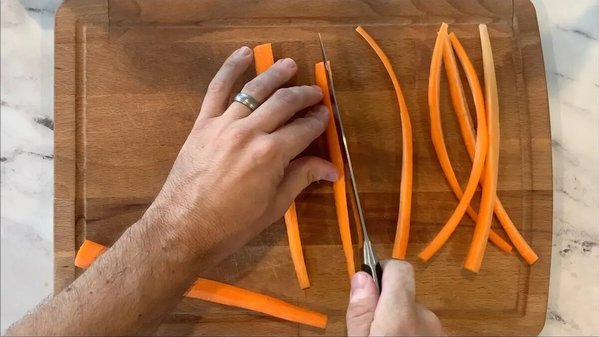 Cut carrots into thin slices to be used in the chicken teriyaki roll.