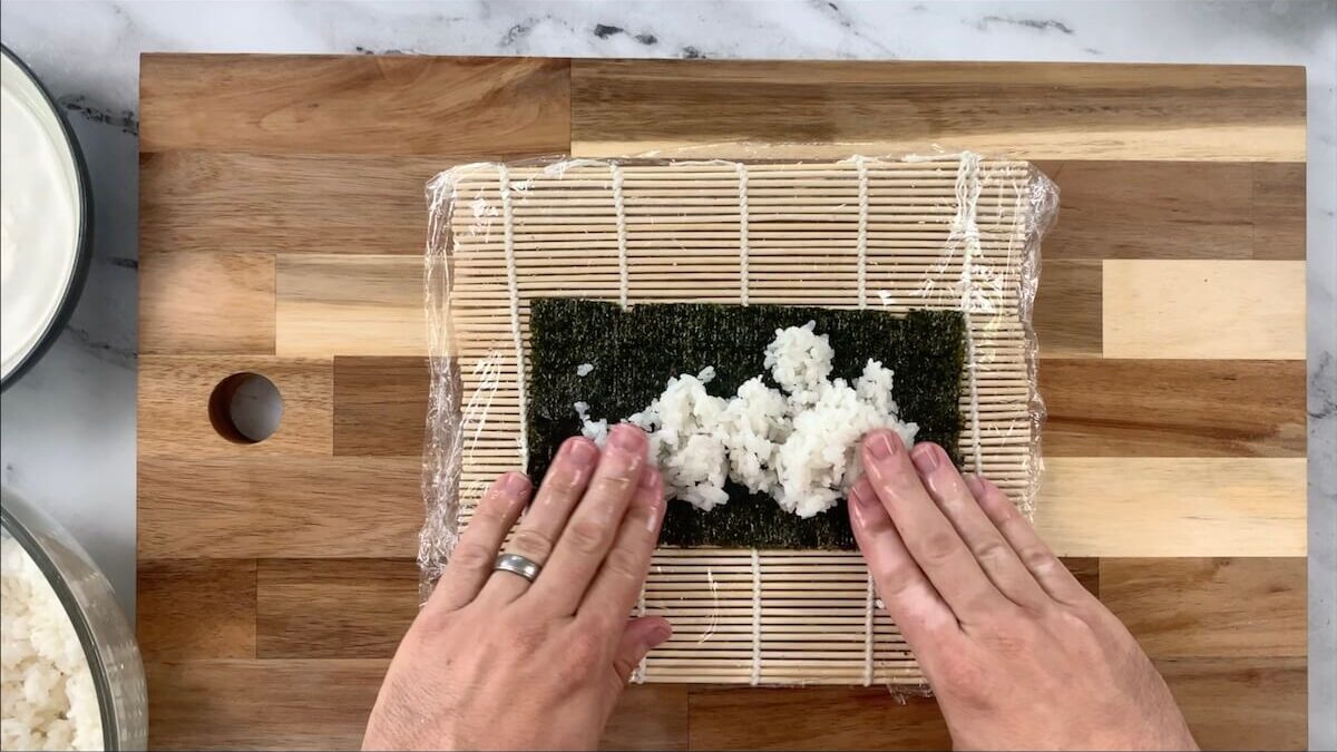 Press rice onto the nori sheet.