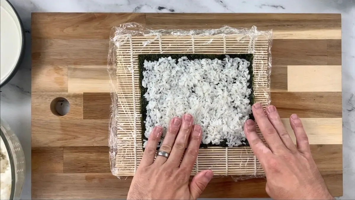 Spread rice onto the nori sheet.