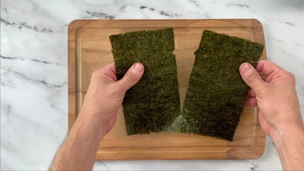 Tear or cut the nori sheet in half.  This helps to make the cucumber rolls bite sized and easier to eat with chopsticks.