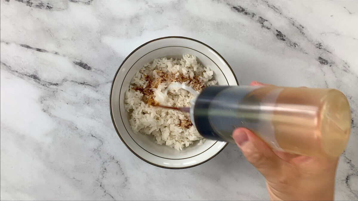 Add 1 1/2 cups of white rice and 2 tablespoons of teriyaki sauce to your bowl.