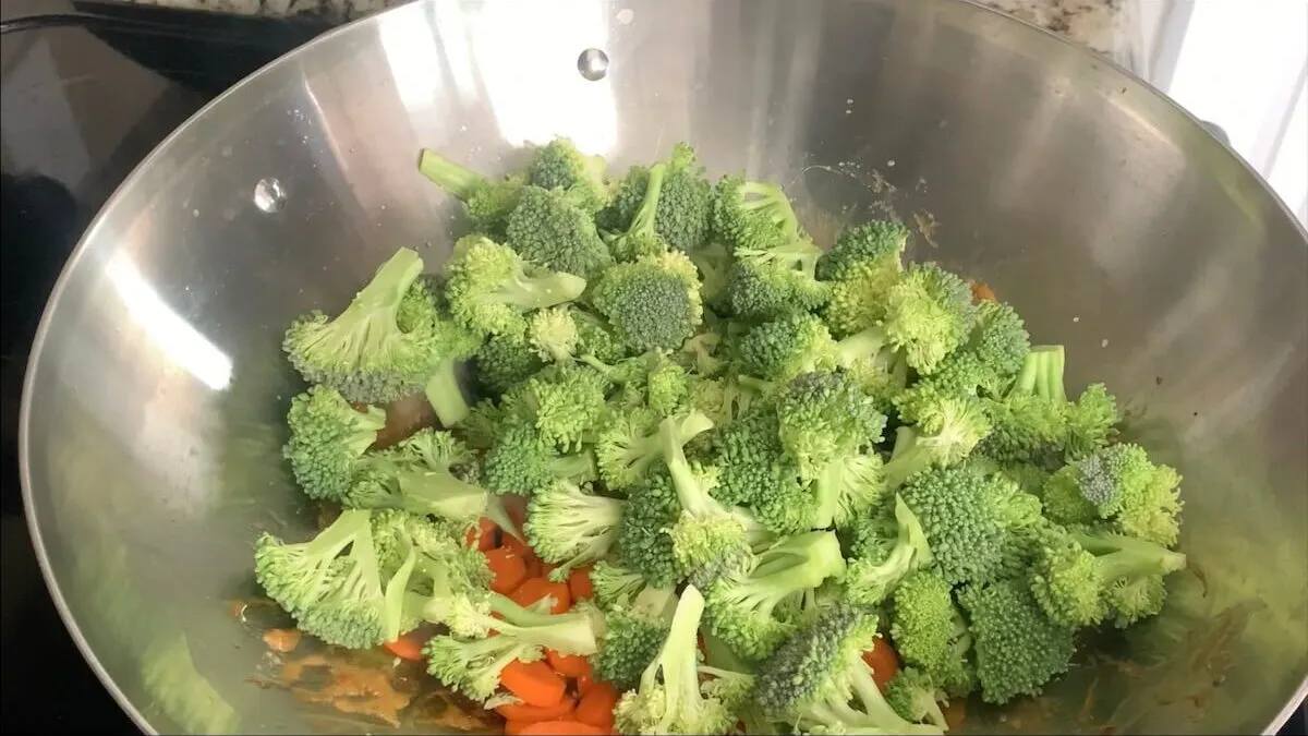 Add oil, broccoli, and carrots to the same pan you cooked the chicken teriyaki and cook for a few minutes on medium heat.