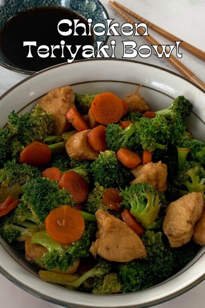 Chicken teriyaki bowl vertical pic on a white plate with chopsticks and a ramekin of teriyaki sauce in the background.