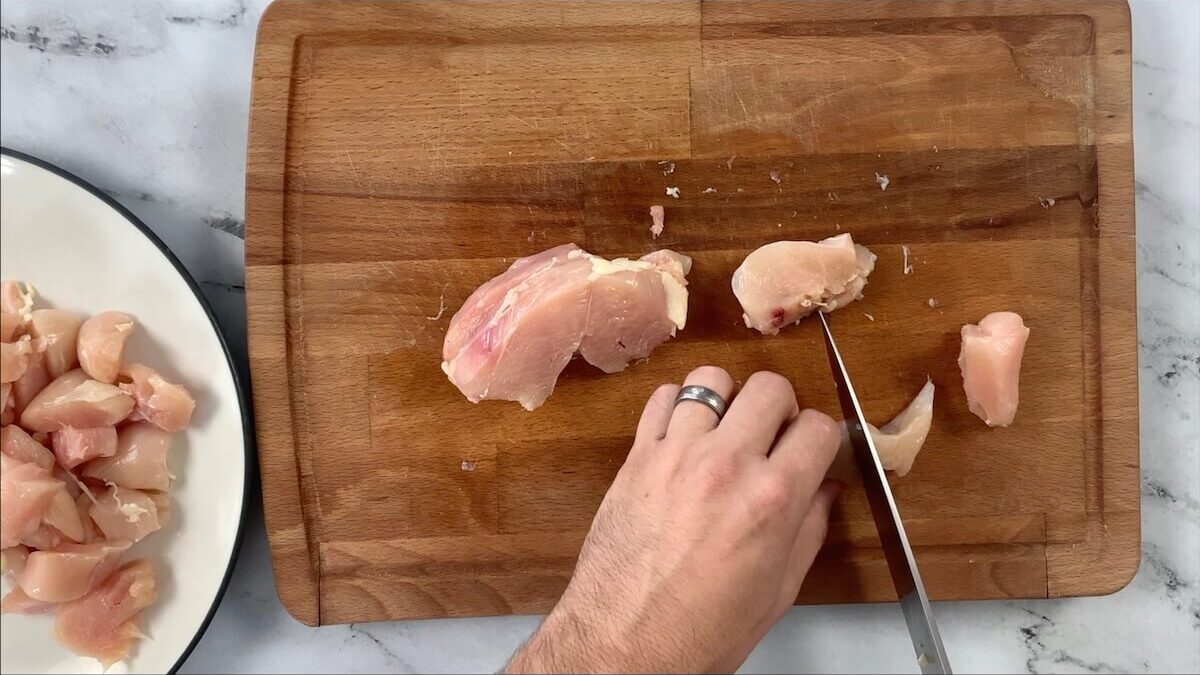 Cut the chicken into bite sized pieces for the chicken teriyaki bowl.