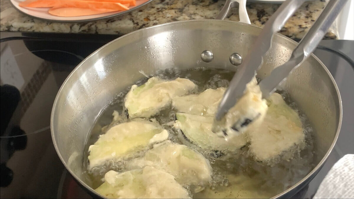 After around a minute and a half, remove the eggplant tempura and add to a paper towel lined plate.