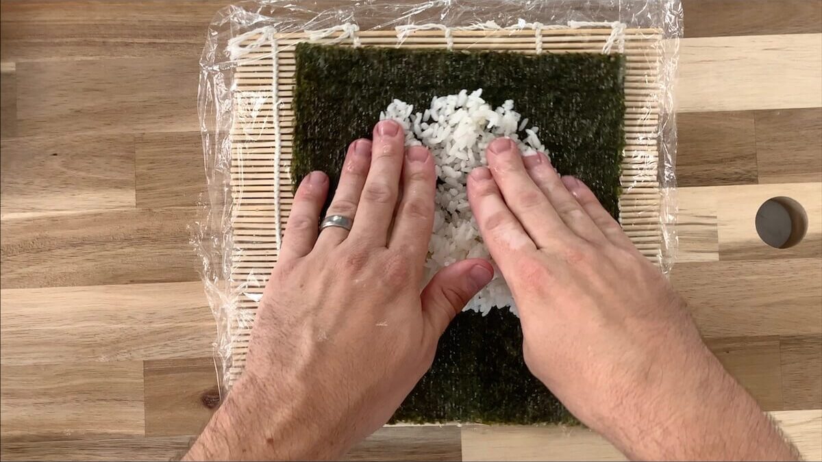 Spread rice onto the nori sheet.