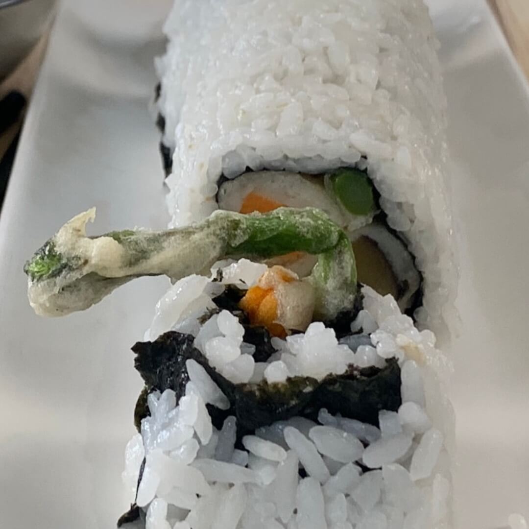 Vegetable Tempura Roll square pic on a white sushi platter.