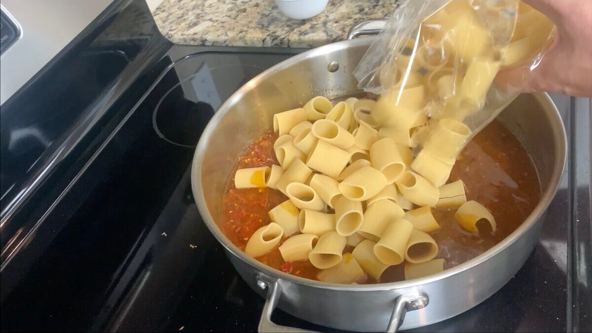 Add rigatoni pasta to the chicken broth and cook for 15 minutes until cooked al dente.