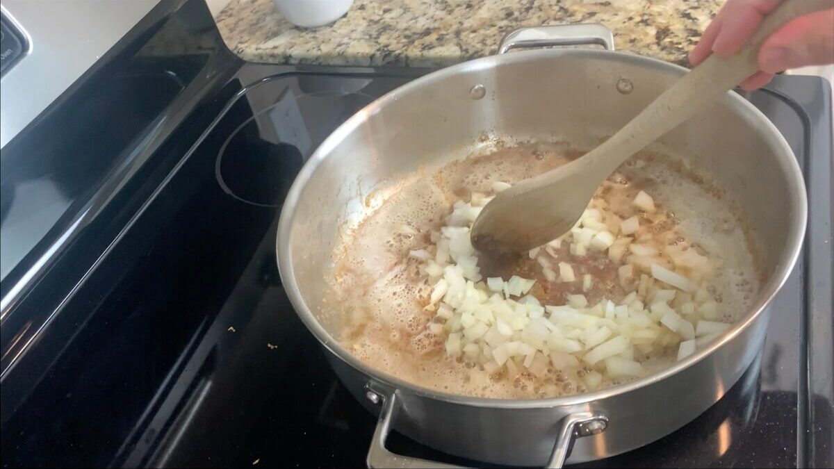 In the same pot that you cooked the chicken, reduce heat to medium, melt the butter and cook onions for 4-5 minutes.