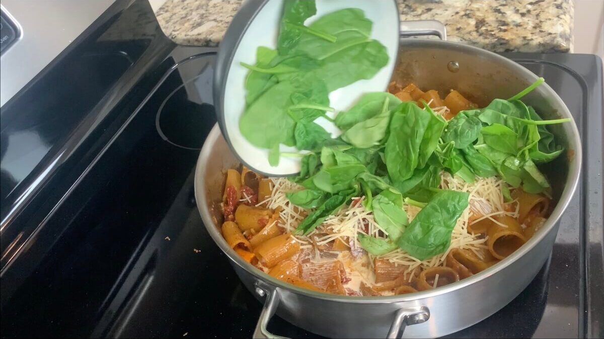 Add tomato paste, cream, parmesan cheese, and spinach and mix together.