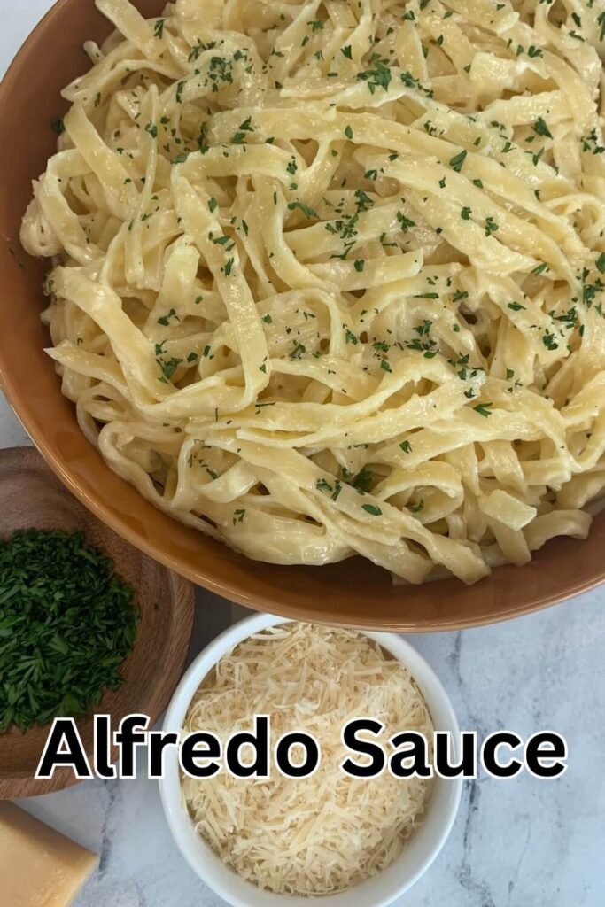 Alfredo sauce over fettuccini garnished with minced parsley.