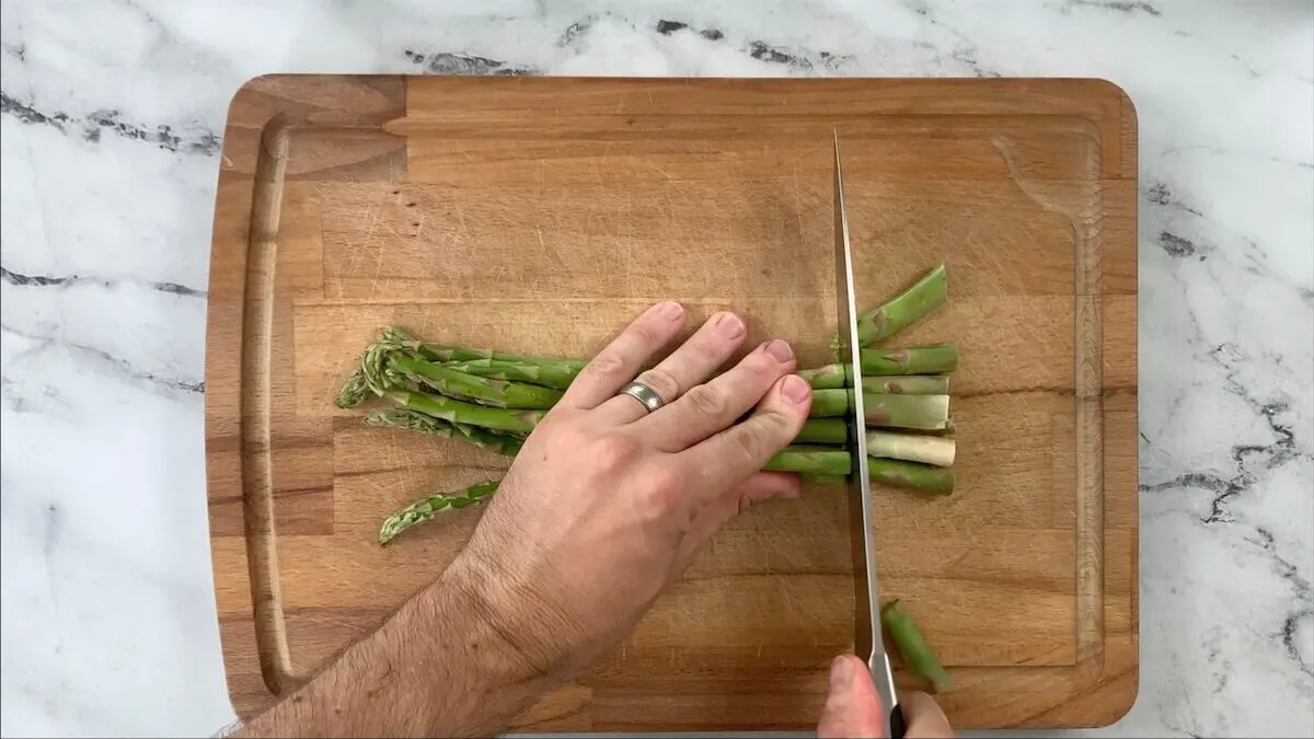 Cut ends off of asparagus.