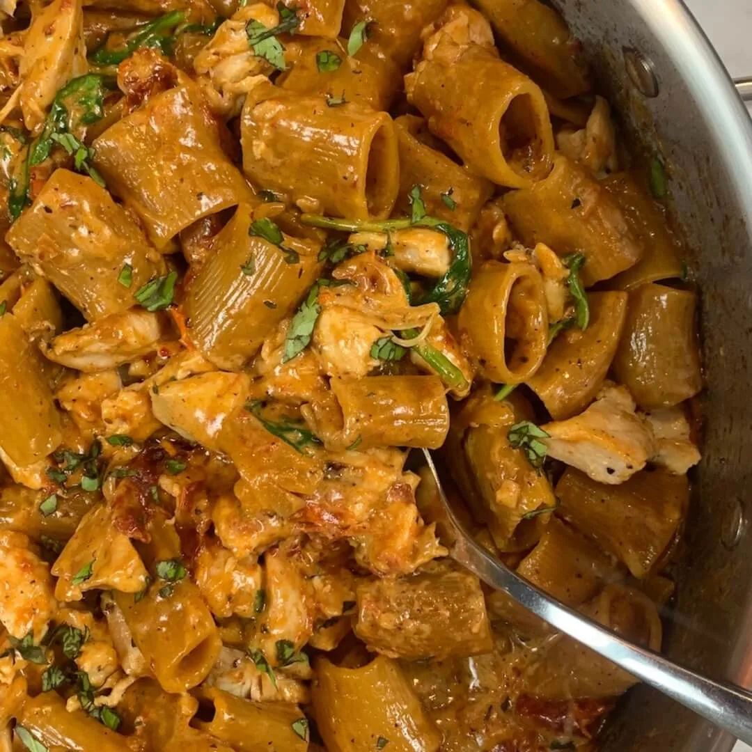 Marry Me Chicken Pasta square pic in a pasta pan with a serving spoon.