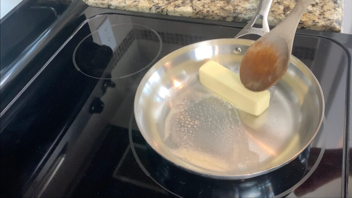 Melt the butter in a skillet to make the Alfredo sauce.