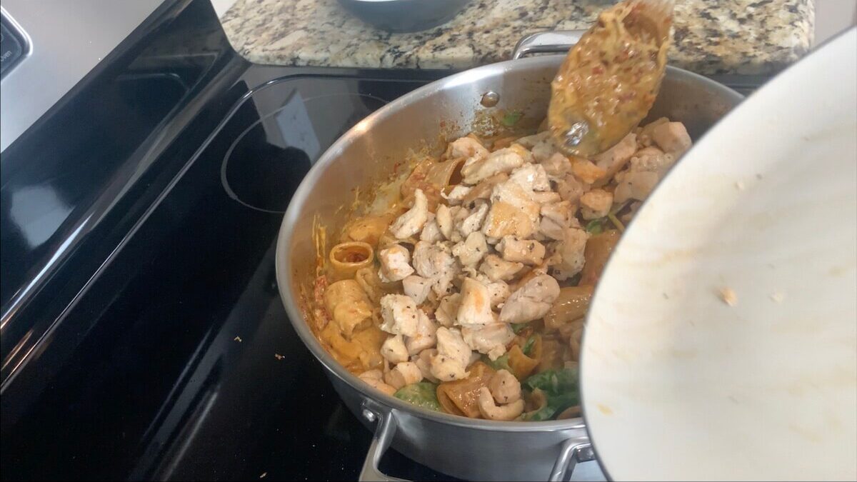 Mix in cooked chicken to complete the marry me chicken pasta.