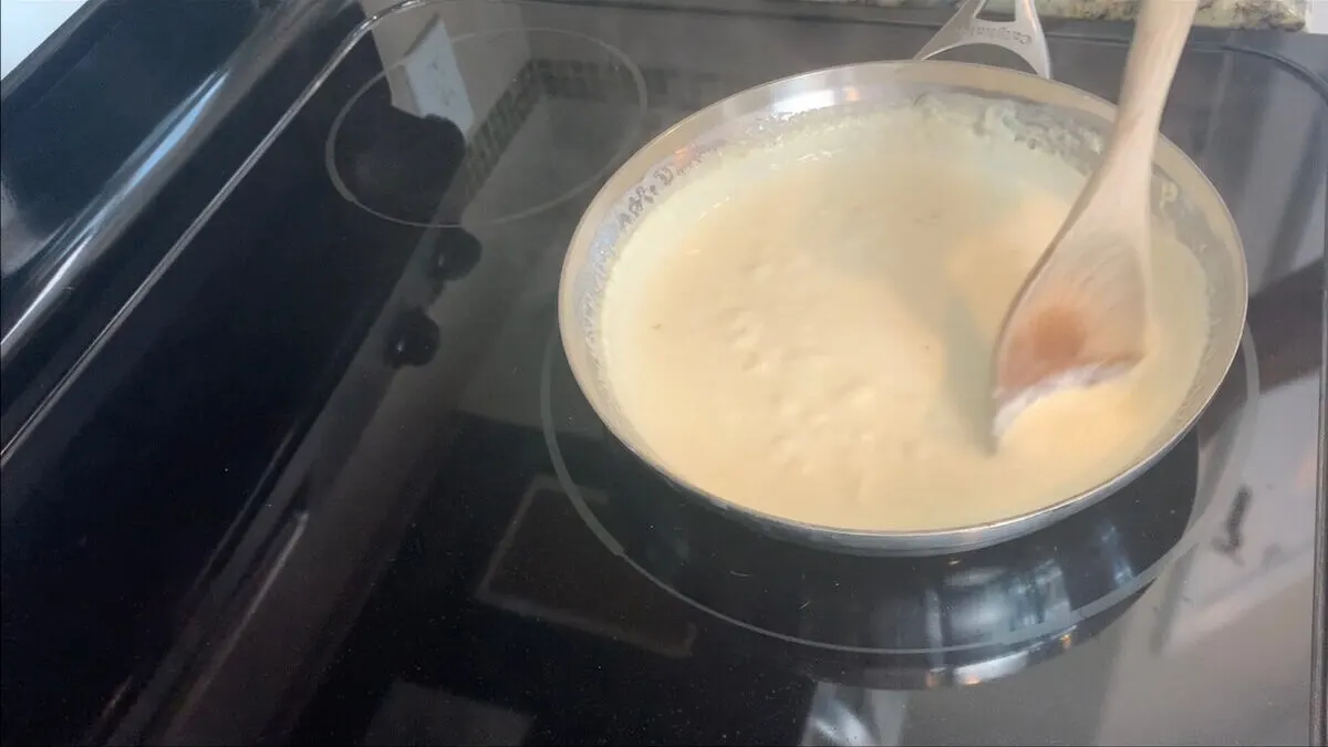 Simmer the heavy whipping cream for five minutes.