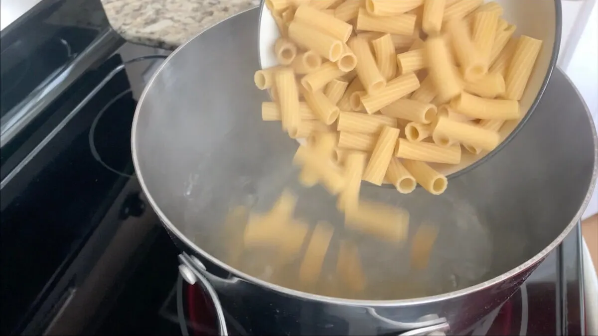 Add noodles to the pot of water to cook.