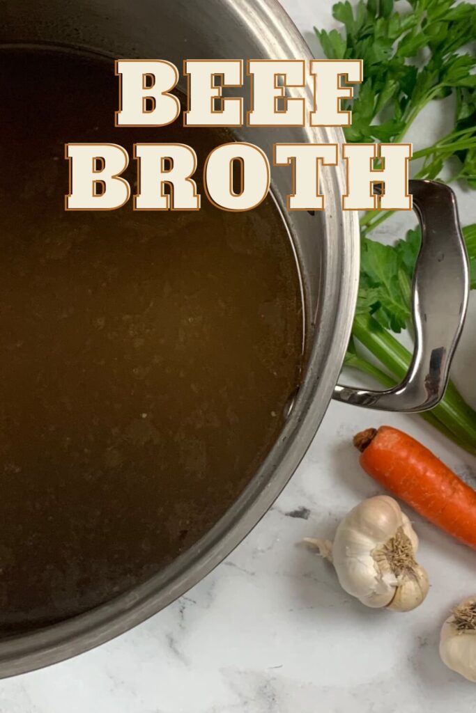 Beef broth vertical pic with herbs and vegetables in the background.