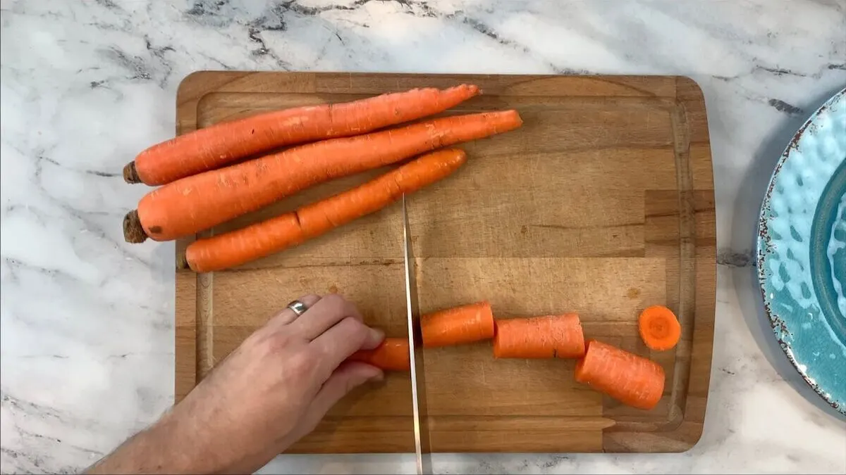 Cut carrots and other vegetables for beef broth.