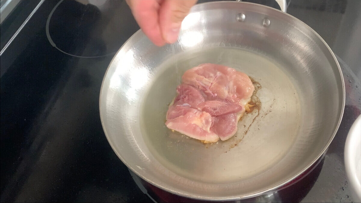 Season chicken with salt and pepper.