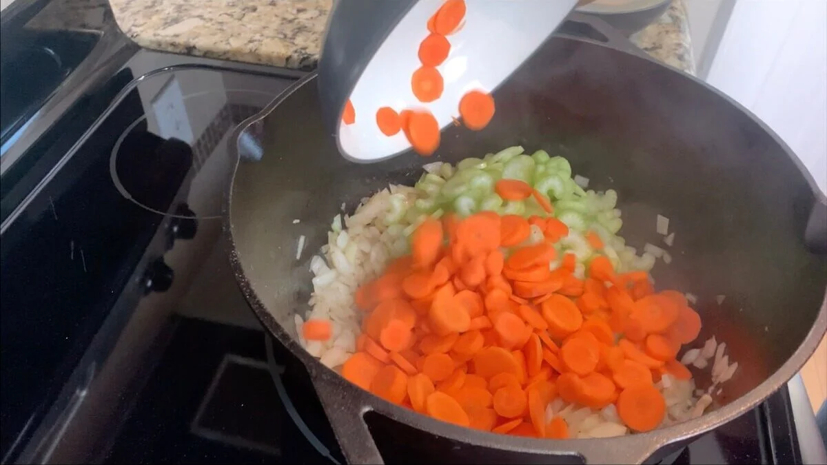 Add carrots and celery to the onions.