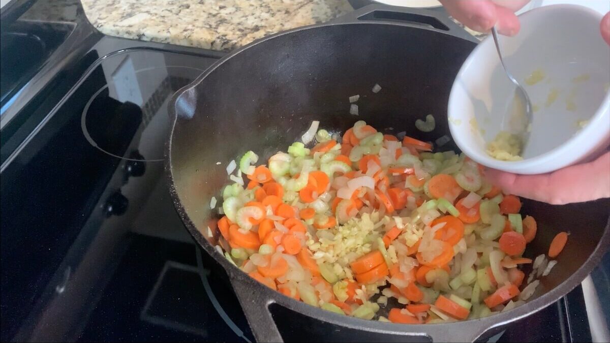 Add garlic to the onions, carrots, and celery.