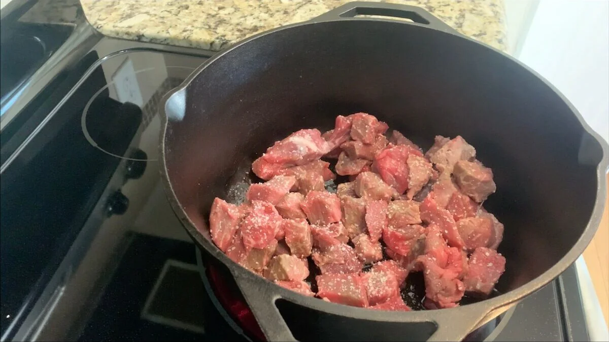 Season with salt and brown the beef in a large pot.