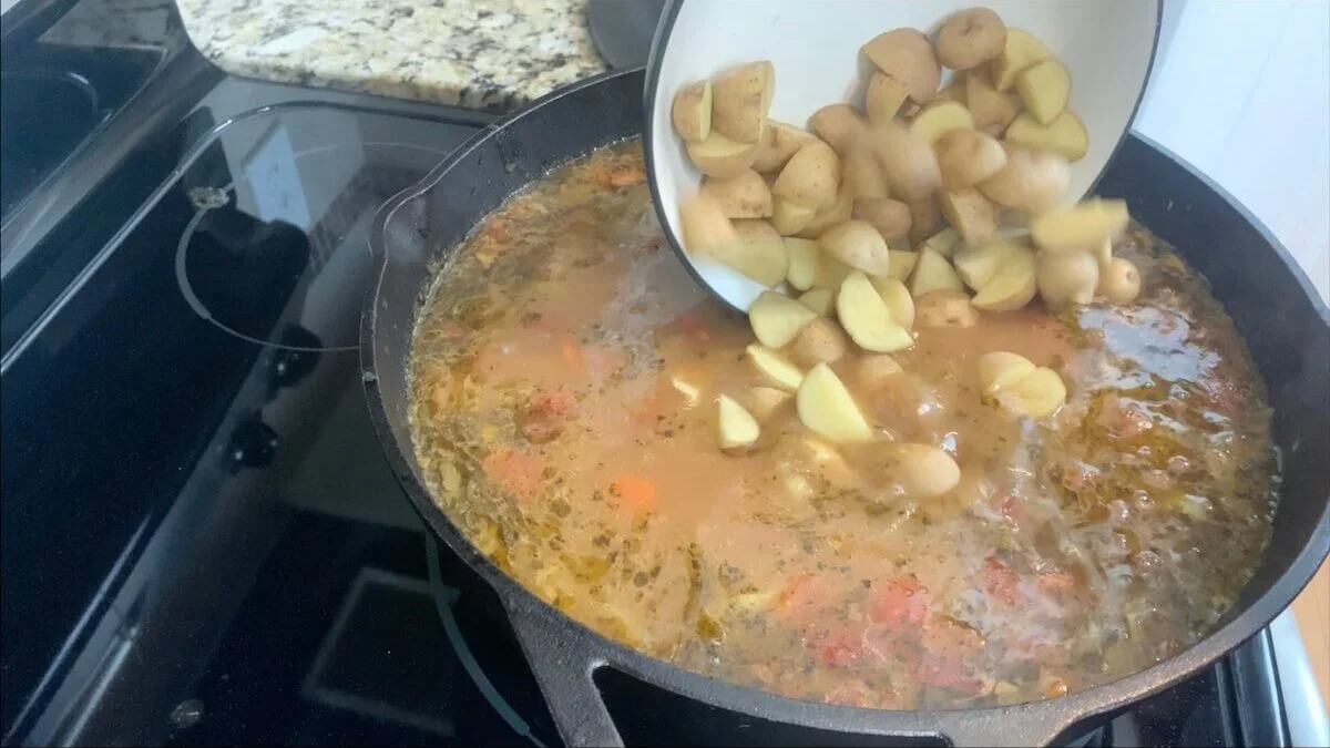 Add potatoes to the vegetable beef soup.